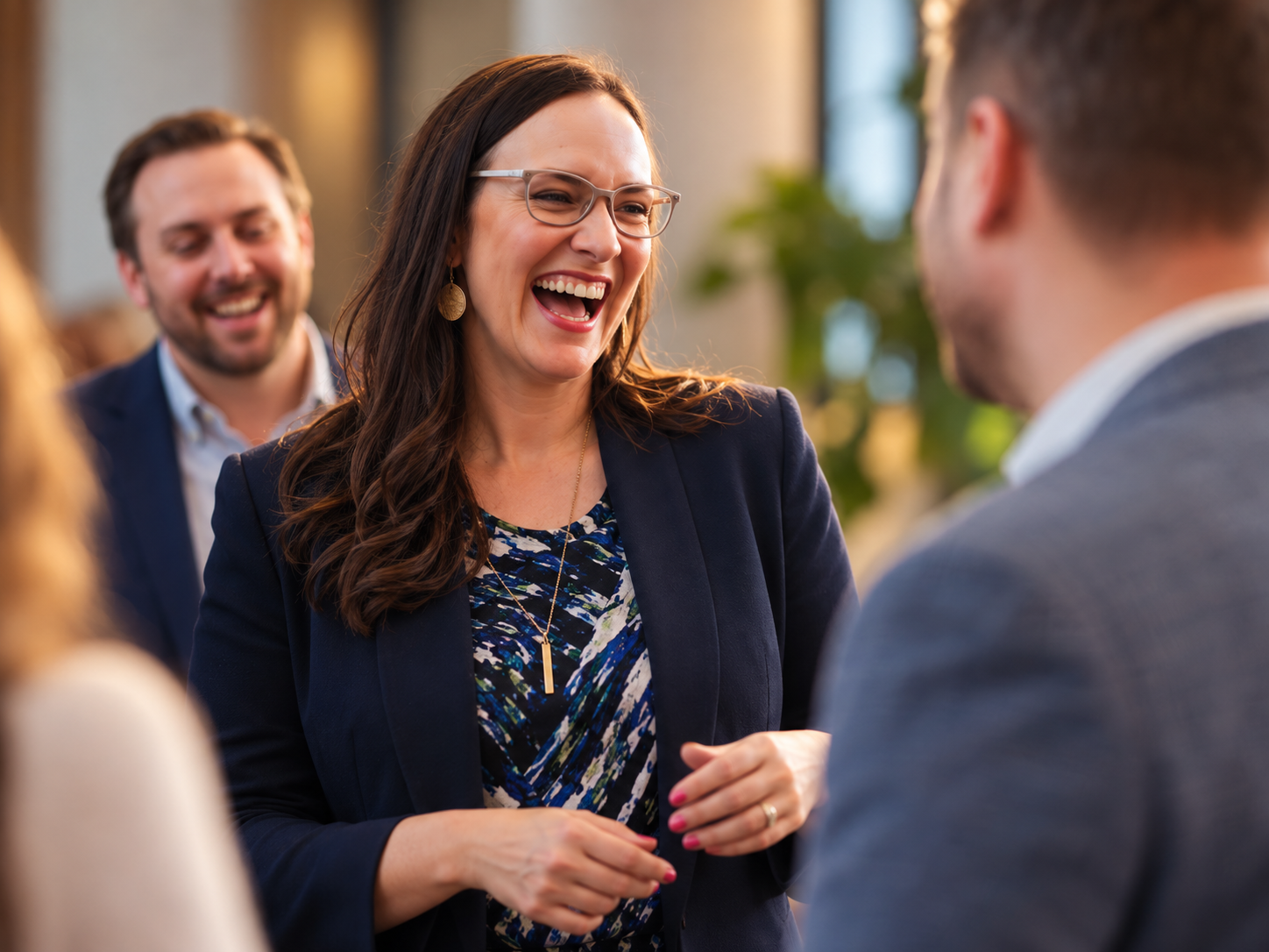 Angela McMillan laughing with team members in a bright office